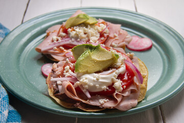 Ham tostadas with cheese and avocado. Mexican food