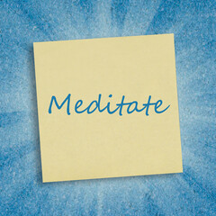 The word Meditate written on a sticky note.