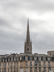 Fototapeta na wymiar Panorama of the old town of Bordeaux, France, with the the tower of the Basilique Saint Michel basilica a cloudy afternoon in winter. it is a gothic catholic cathedral basilica.....