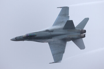 Military fighter aircraft in a turn with high g forces.