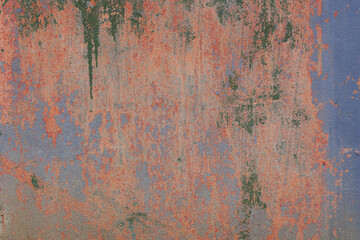 Grunge classic blue concrete background. Textured plaster wall. Orange and green elements in backdrop. Color of the year 2022 concept. Top view, layout for design. Surface with peeling shabby pattern.