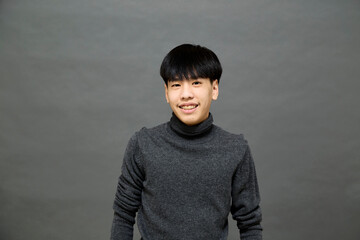 Young handsome Asian man posing at studio