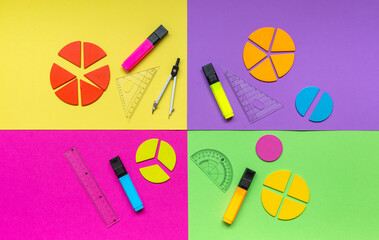 Colorful math fractions, rulers on a green yellow magenta violet background. Interesting, fun math for kids. Education, back to school concept