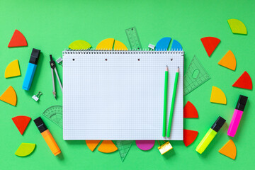 School supplies, open notepad, rulers, fractions on a green background. Interesting, fun math for...