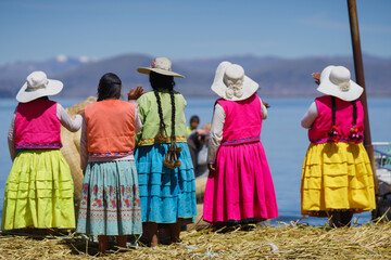 Mujeres despidiéndose en las islas flotantes del lago Titicaca