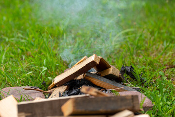 Lighting a fire with wood. The concept of making a campfire, baking sausages and other food.