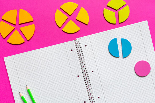 School supplies, open notepad, rulers, fractions on a magenta pink background.  Interesting, fun math for kids. Education, back to school concept	