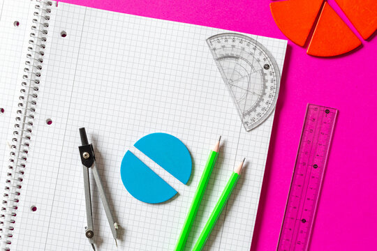 School supplies, open notepad, rulers, fractions on a magenta pink background.  Interesting, fun math for kids. Education, back to school concept	