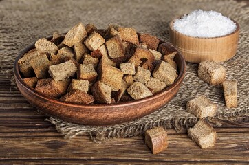 Homemade bread toasts. Crispy pieces of bread in a bowl on the table.