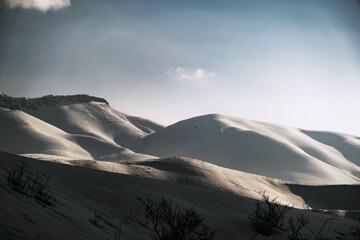 Fototapeta na wymiar Landscape view of a mountain with snow, blue sky and some clouds