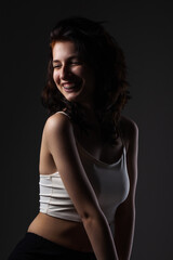 Fototapeta premium Beautiful tenage girl with dental braces. Studio portrait against dark background..