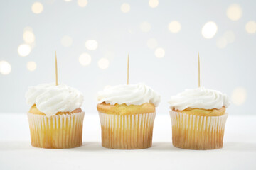 Three Vanilla Cupcakes Topper Mockup. Styled against a white background with bokeh party fairy...
