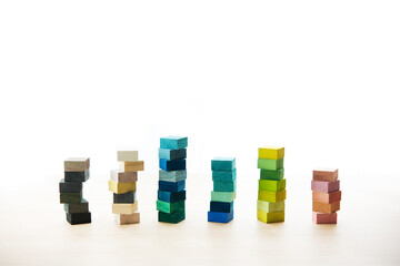 Colored wooden block stacked in a bar graph like manner. Placed on a light colored wooden table...