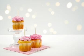 Pink Strawberry Cupcake Topper Mockup. Styled against a white background with bokeh party fairy lights. Copy space for your design here.