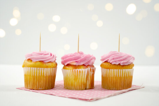 Pink Strawberry Three Cupcakes Topper Mockup. Styled against a white background with bokeh party fairy lights. Copy space for your design here.