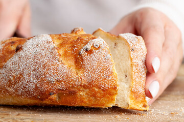 a fresh soft loaf of bread cut into pieces with a knife