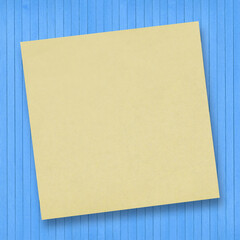 Wooden background with sticky note.