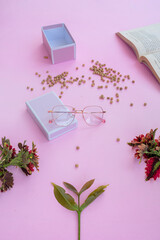 Product Presentation of Minimalist Concept Idea. square glasses, gift box and dry leaves on pink paper background.