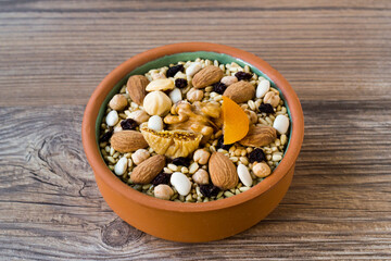 Uncooked Ingredients Of Traditional Turkish Dessert Asure,Noah's Pudding in the casserole bowls on wooden surface.Conceptual design of Asure Day.
