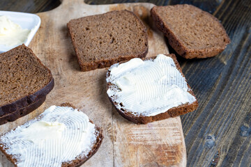 slices of black sliced bread with butter spread from milk
