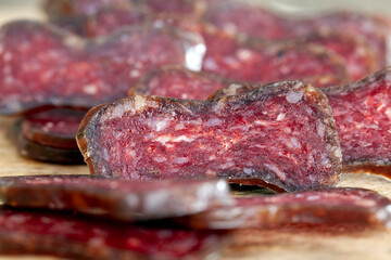 sliced piece of cured sausage on the table