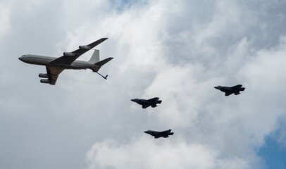 Three Israeli Stealth Fighter Jets Flying in Formation together with a Refueling Jumbo Jet in the...