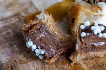 decorated dessert of sweet puff pastry with chocolate filling and natural honey