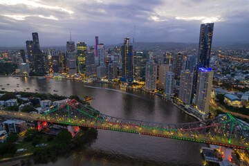 Aerial Brisbane City, Queensland Australia Downtown Region Aerial Night Highway cars streak Sunset...