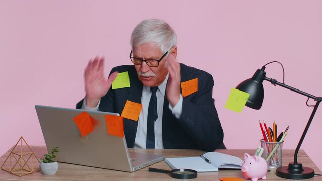 Tired exhausted fatigue senior business man office employee manager sits in office table with laptop sticky notes sticks with many tasks inscription help, feels sad boredom overworked multitasking
