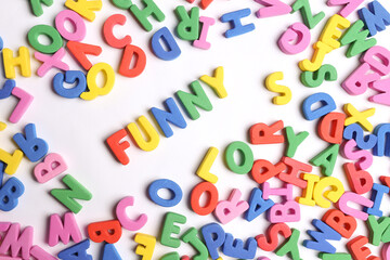 Fun word written in colored letters on a white background and with loose letters around it. Fun word written in colored letters on a white background