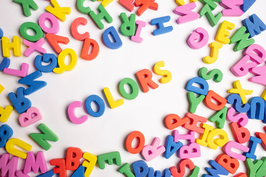 Image Color word formed with colored letters and a group of single letters around them on white background. 
