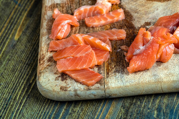 cutting fish fillets during the preparation of a dish of red salmon fish