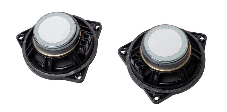 Two speakers of an acoustic system - an audio for playing music in a car interior on a white isolated background in a photo studio. Spare parts for auto repair in a workshop or for sale for tuning.