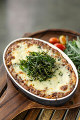 fresh beef lasagna in oven dish on table in rome italy restaurant