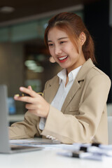 Fototapeta na wymiar Charming Asian Business Woman talking with customer by video call. Finance and Real Estate Agent concept.