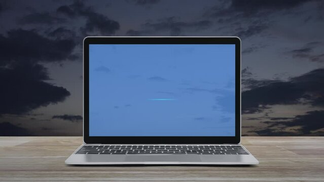 Bank flat icon on modern laptop computer monitor screen on wooden table over sunset sky, Business banking online concept