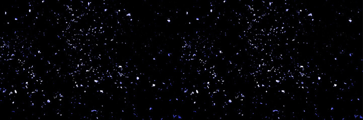 Carnival confetti different sizes on the blackbackground.