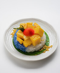 Ripe Mango with Coconut Flavored Sticky Rice on white dish, .Popular Thai desserts,Food and Desserts concept.
