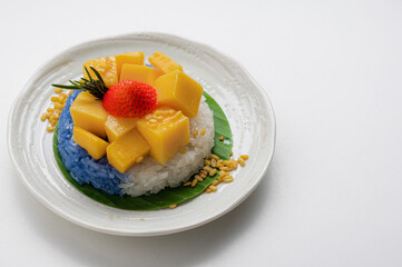 Ripe Mango with Coconut Flavored Sticky Rice on white dish, .Popular Thai desserts,Food and Desserts concept.