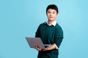 Young Asian copywriter smiling wearing green casual shirt hold in hand using laptop pc computer...