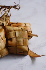 a bunch of ketupat or rice cake wrapped in coconut leaves 