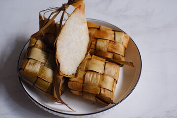a bunch of ketupat or rice cake wrapped in coconut leaves 
