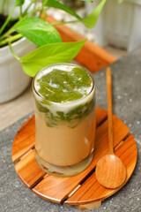 a glass of iced coffee with green grass jelly 