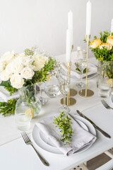 The wedding decor. Wedding teble decoration with white roses