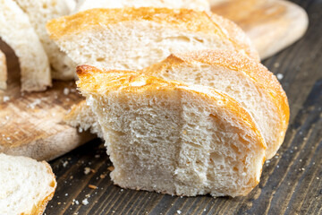 sliced loaf of bread on a cutting wooden board