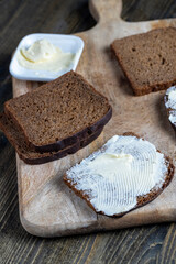 slices of black sliced bread with butter spread from milk