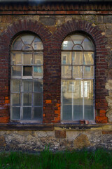 windows and red brick facade of old abandoned factory building in Germany