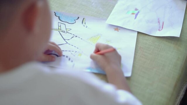 child draws with chalk