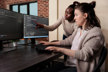 Blockchain engineer pointing out mistake in network security software line code. Cybernetics...