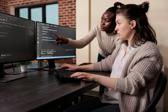 Blockchain engineer pointing out mistake in network security software line code. Cybernetics developers engineering system updates and processing data blocks uploaded by artificial intelligence.